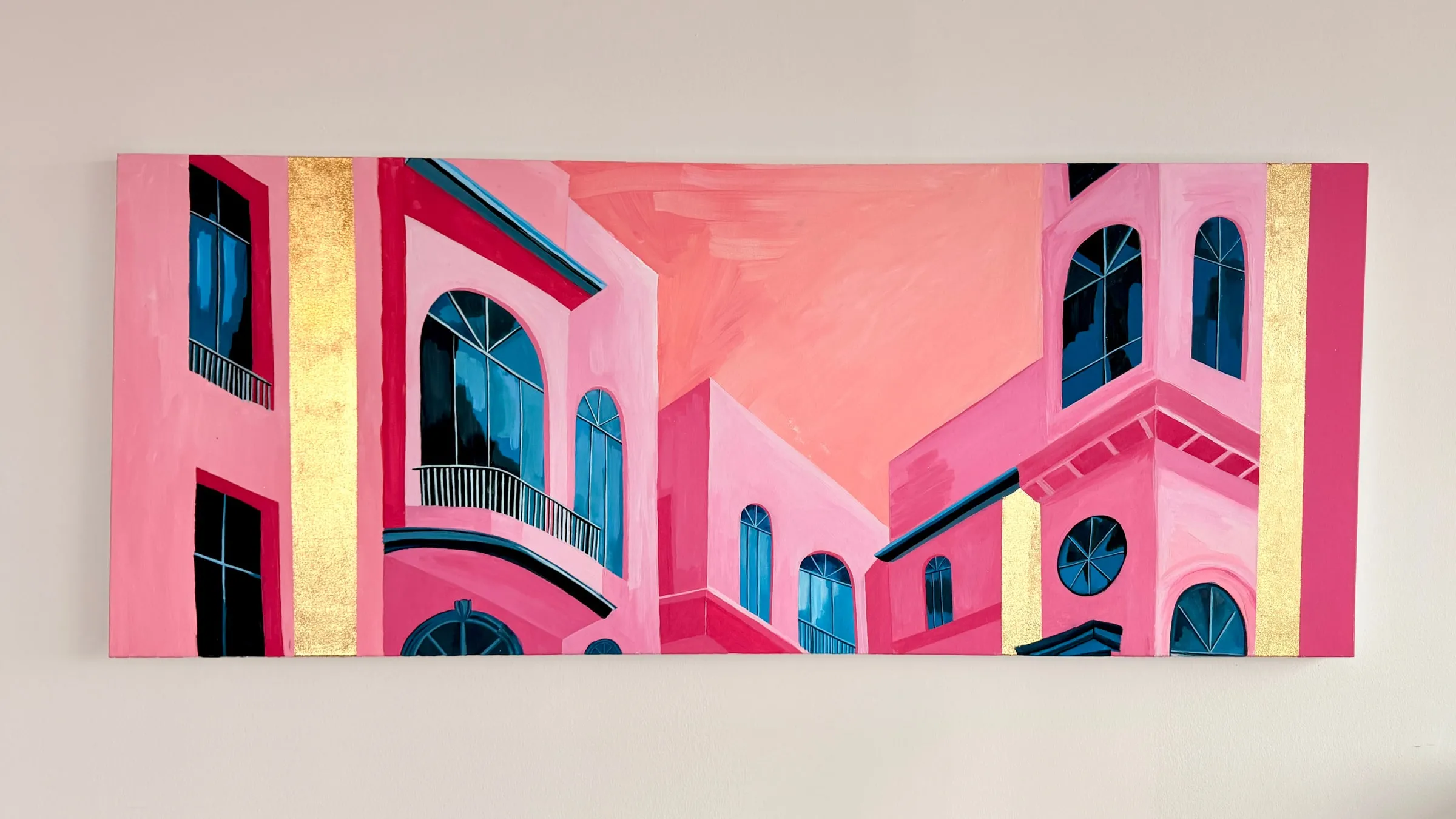 Painting of pink and white Mediterranean buildings with arched windows